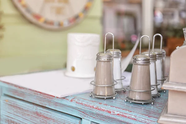 Pepper and salt shakers on vintage table — Stock Photo, Image