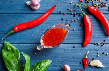 Biber sosu, biber bakla ve tahıl ahşap arka plan üzerinde kompozisyonu