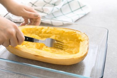 Kadın mutfakta spagetti squash hazırlanıyor