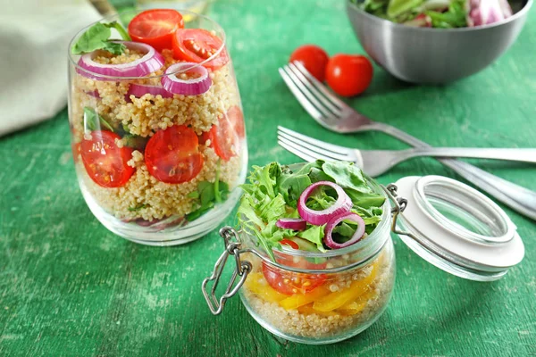 Composition with quinoa and vegetables in glassware on table — Stock Photo, Image