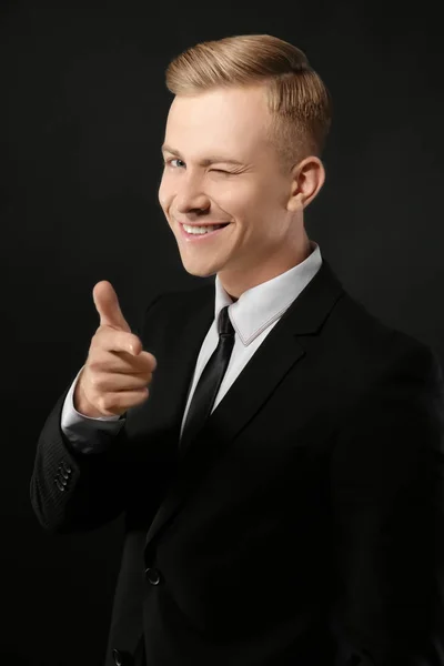 Portrait of young man in suit on black background — Stock Photo, Image