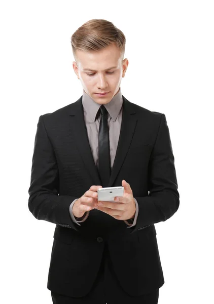 Jovem empresário com telefone no fundo branco — Fotografia de Stock