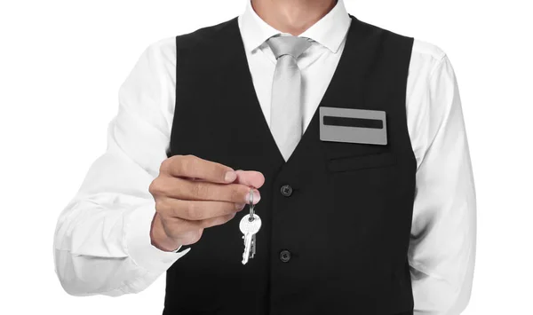 Male receptionist with key from hotel room on white background — Stock Photo, Image