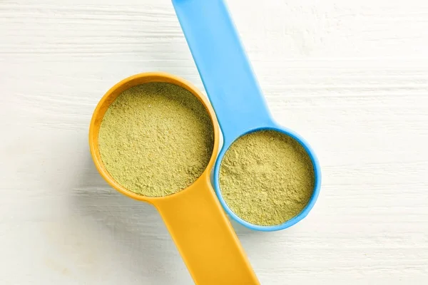 Hemp protein in scoops on table — Stock Photo, Image