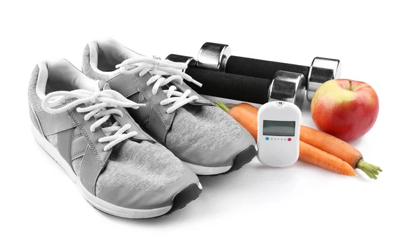 Zusammensetzung mit digitalem Glukometer und Sportinventar auf weißem Hintergrund. Diabetes-Konzept — Stockfoto