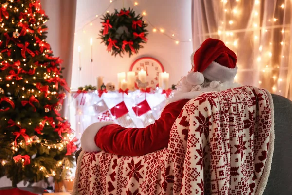 Authentieke Kerstman zitten in een leunstoel bij kamer ingericht voor Kerstmis — Stockfoto