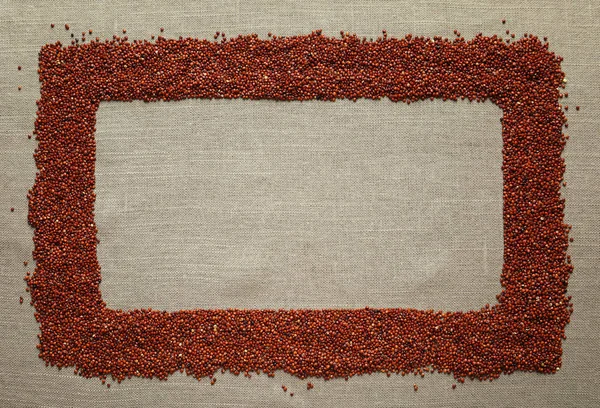 Red quinoa seeds on sackcloth — Stock Photo, Image