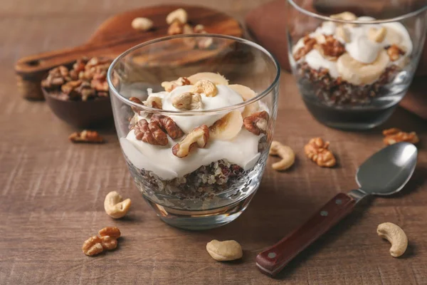 Tasty quinoa with nuts in glass on table — Stock Photo, Image