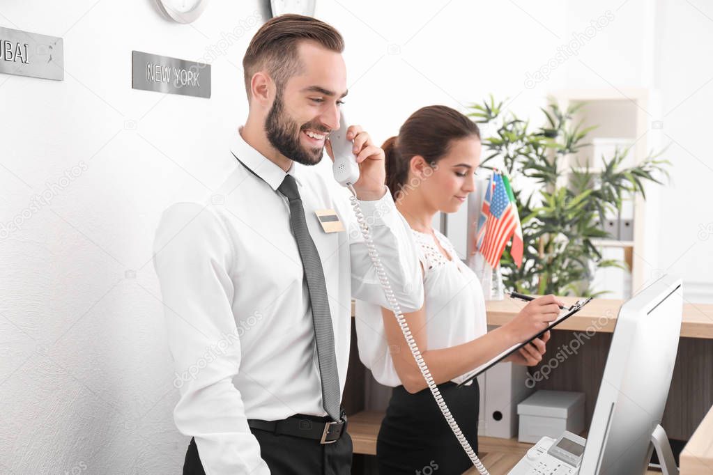 Two hotel receptionists at workplace