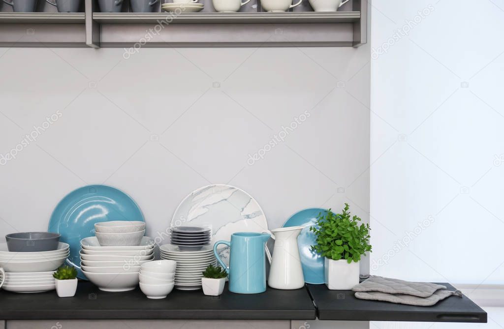 Cupboard with cups and different dishes 