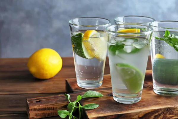 Board with glasses of basil water on table — Stock Photo, Image