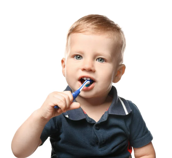 Adorable little boy brushing teeth on white background — Stock Photo, Image