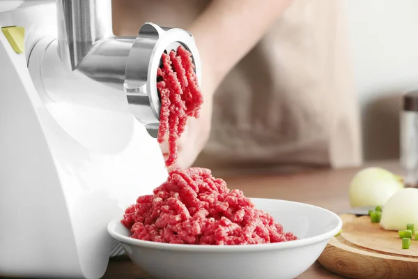 Woman using grinder for preparation of minced meat — Stock Photo, Image