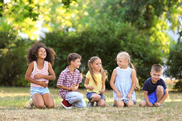 Groupe d'enfants assis dans le parc — Photo