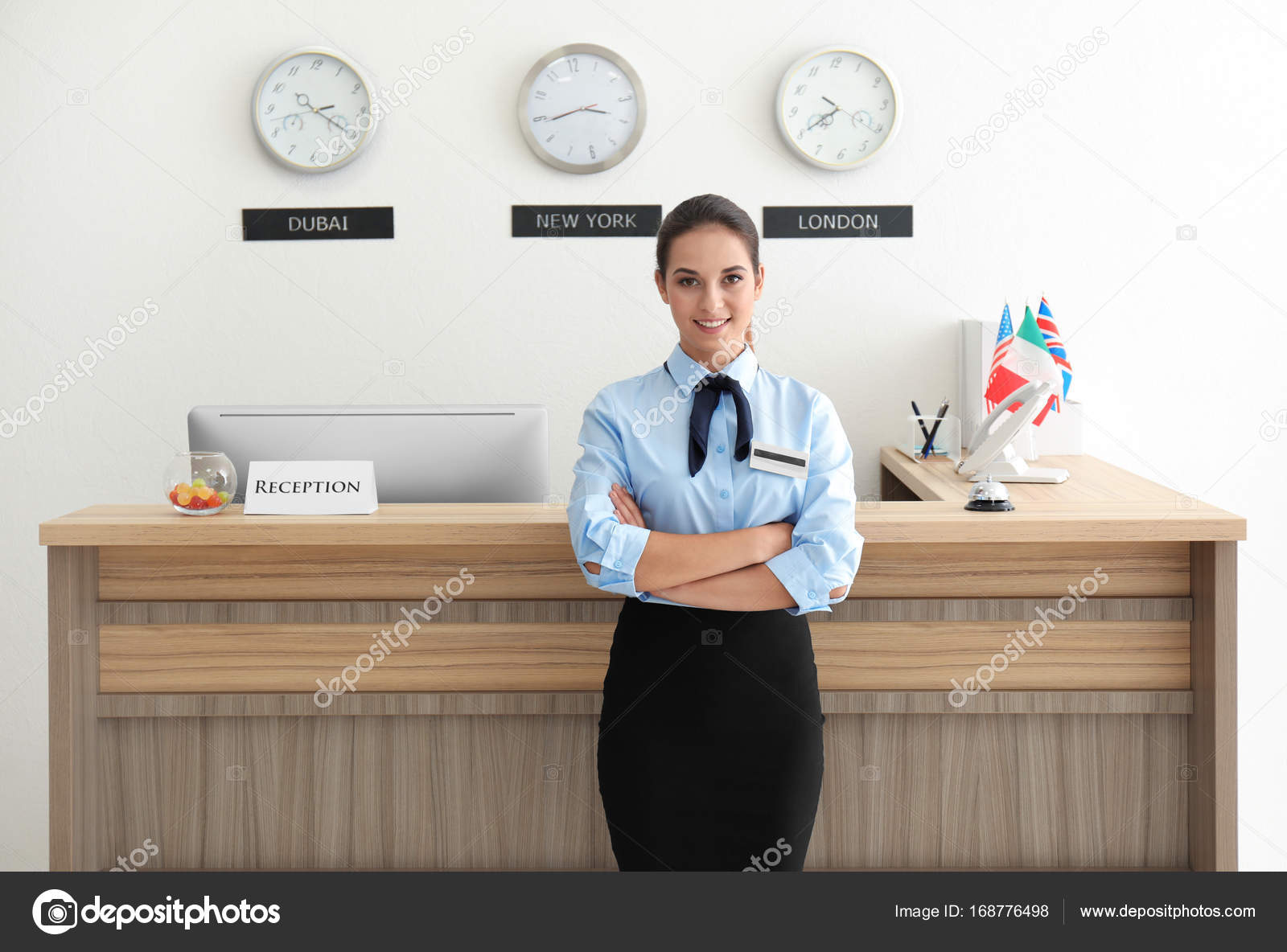 Female hotel receptionist at workplace Stock Photo by ©belchonock 168776498