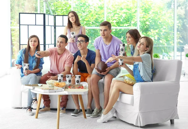 Vänner tittar på TV hemma — Stockfoto
