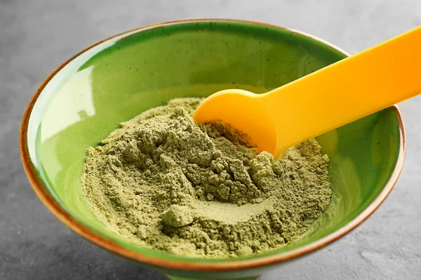 Bowl of hemp protein powder with spoon on table — Stock Photo, Image
