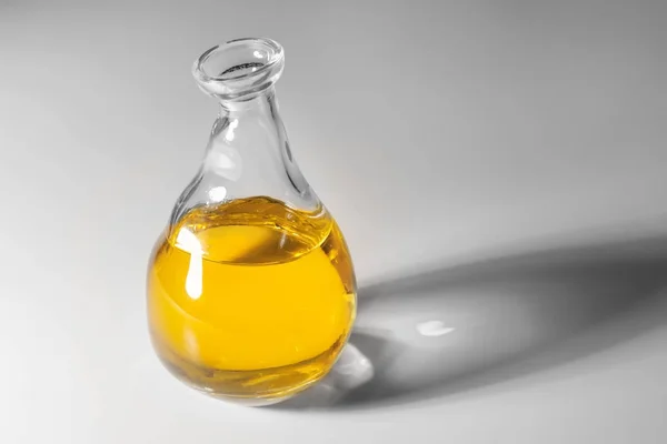 Glass jug with cooking oil — Stock Photo, Image