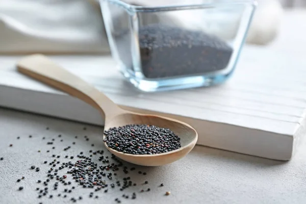 Black quinoa and wooden spoon — Stock Photo, Image