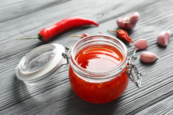 Glass jar with chili sauce — Stock Photo, Image