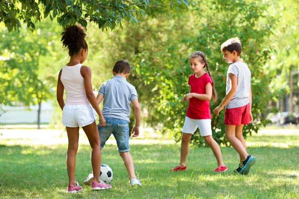 Cute children playing football in park — Stock Photo, Image