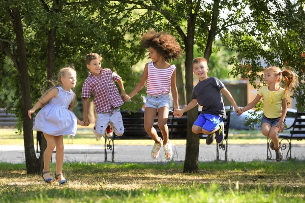 Group of children jumping in park — Stock Photo, Image