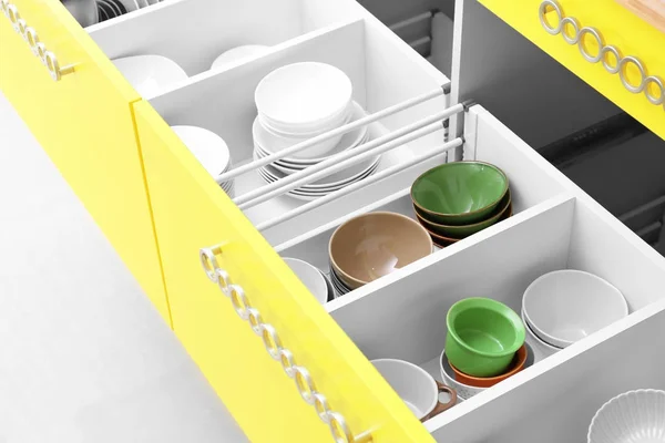 Set of tableware in kitchen drawers — Stock Photo, Image