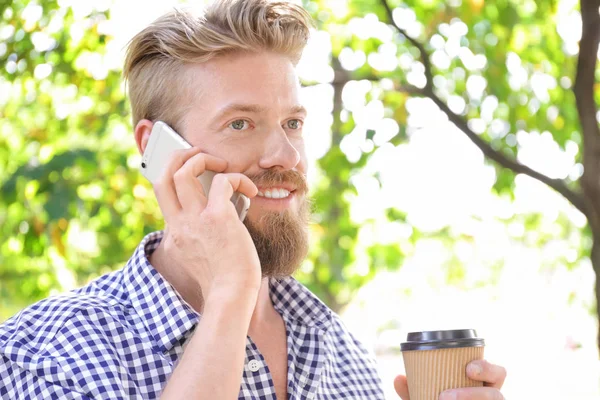 Park telefonda konuşan genç hipster adam — Stok fotoğraf