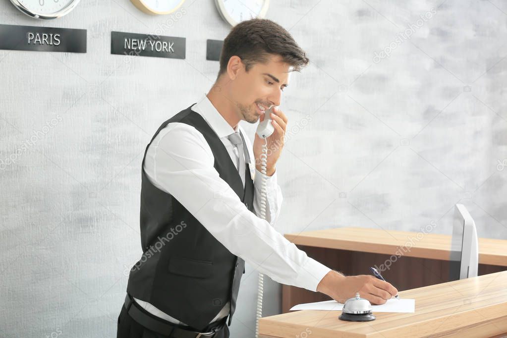 Male receptionist working in hotel