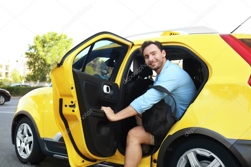 Young man in taxi car