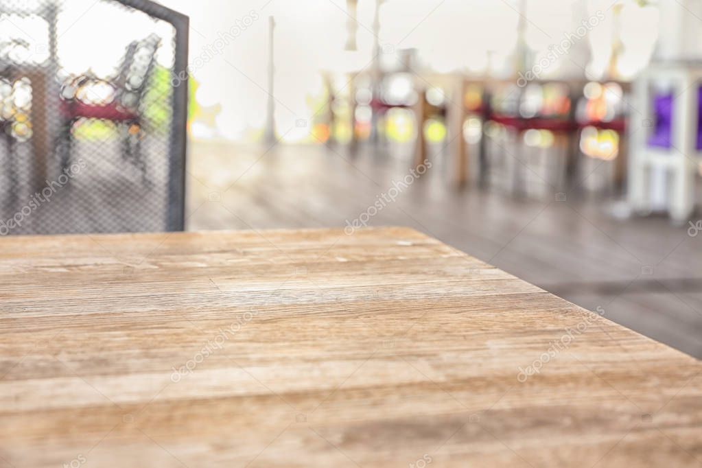 Wooden table on blurred background, closeup