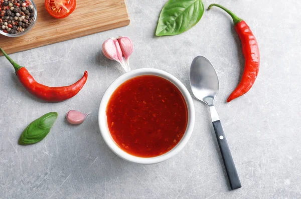 Composition with chili sauce in bowl — Stock Photo, Image