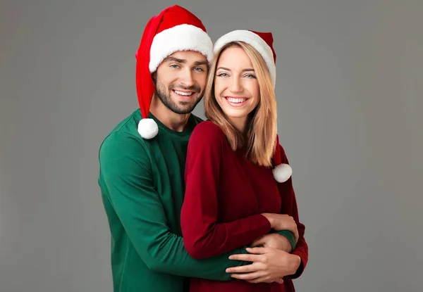 Junges Paar in Weihnachtsmannhüten — Stockfoto