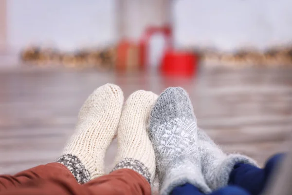 Legs of young couple in warm socks at home. Christmas concept — Stock Photo, Image