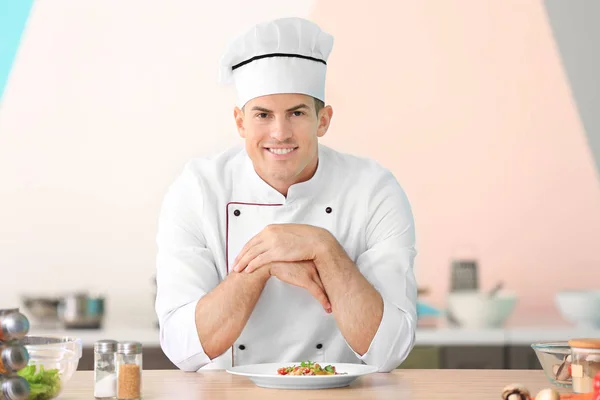 Young male chef in kitchen — Stock Photo, Image