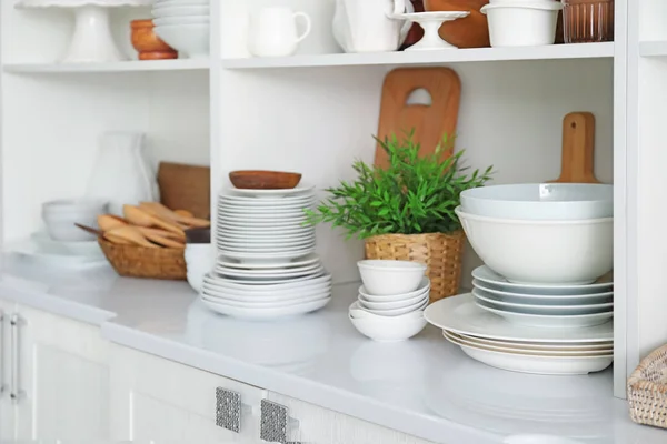 White storage stand with ceramic dishware — Stock Photo, Image