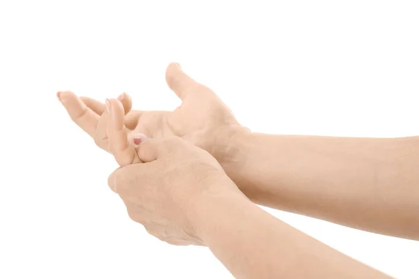 Elderly woman suffering from pain in hand on white background — Stock Photo, Image