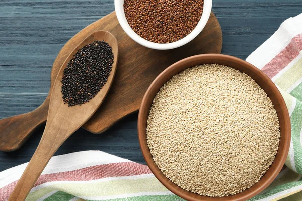 White, red and black quinoa in dishware — Stock Photo, Image