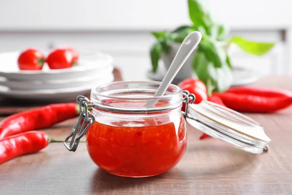 Composition with tasty chili sauce in jar — Stock Photo, Image