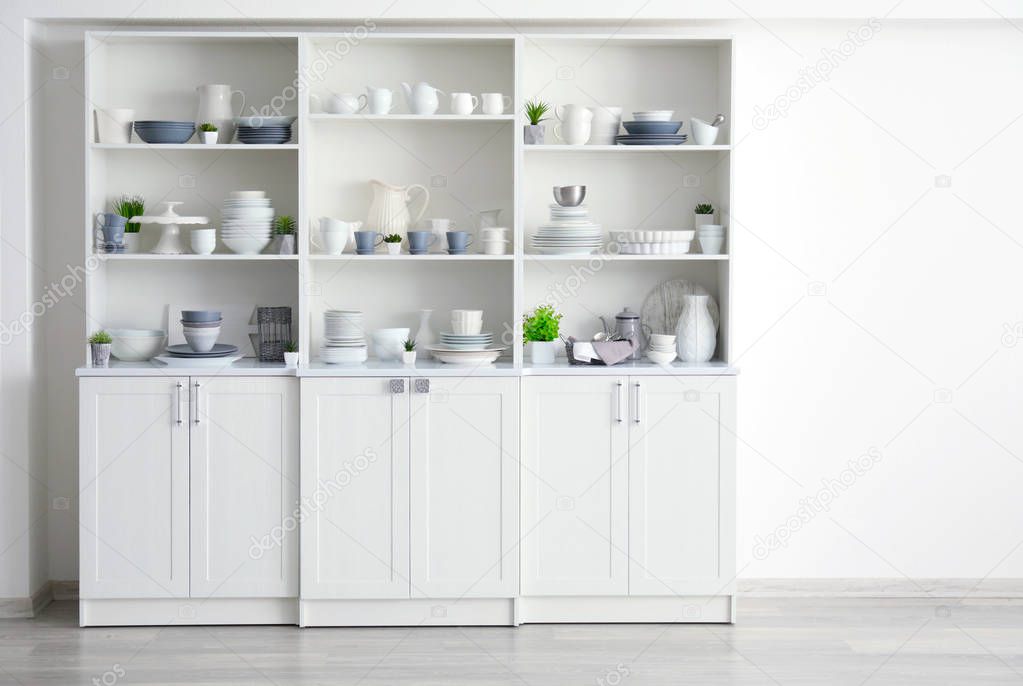 White storage stand with ceramic dishware in kitchen