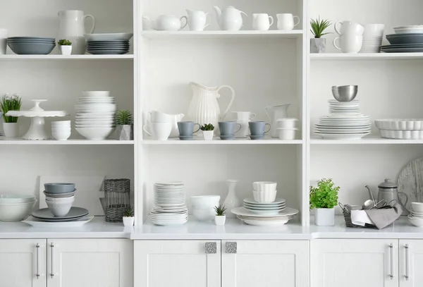 White storage stand with ceramic dishware in kitchen