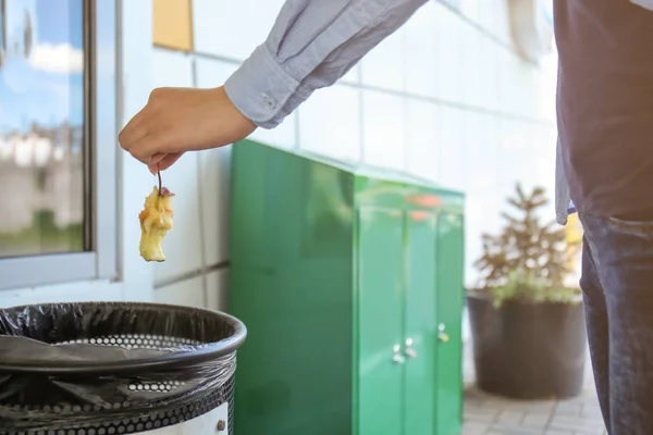 쓰레기 bin으로 애플 그 루터 기를 던지는 여자 — 스톡 사진