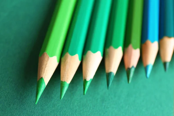 Many pencils on green background — Stock Photo, Image