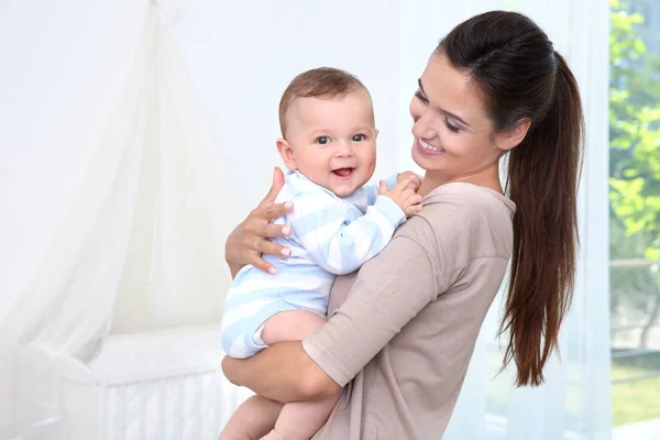 Mother holding cute baby after bathing at home — Stock Photo, Image