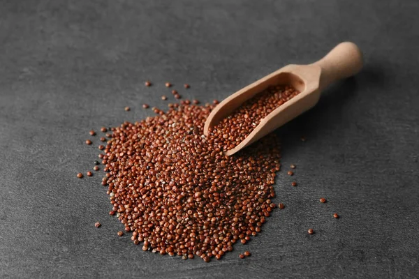 Scoop with quinoa seeds on table — Stock Photo, Image