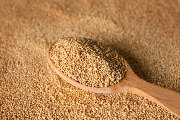 Spoon with quinoa on seeds — Stock Photo, Image
