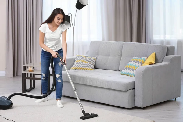 Vrouw schoonmaak tapijt met vacuüm — Stockfoto