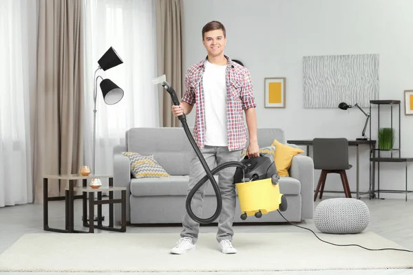 Man with steam vapor cleaner in living room — Stock Photo, Image