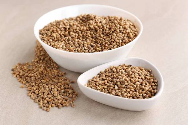 Bowls with hemp seeds on light background — Stock Photo, Image