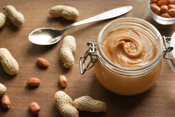 Glass jar with creamy peanut butter — Stock Photo, Image
